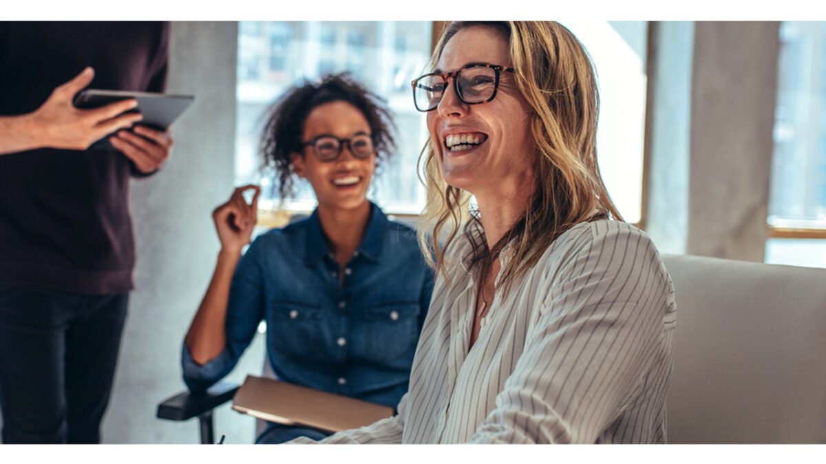 Laughing group of people in front of laptop