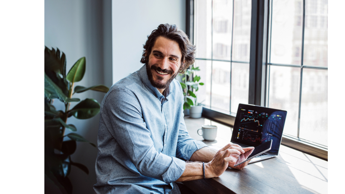 Man with beard smiles at his workplace