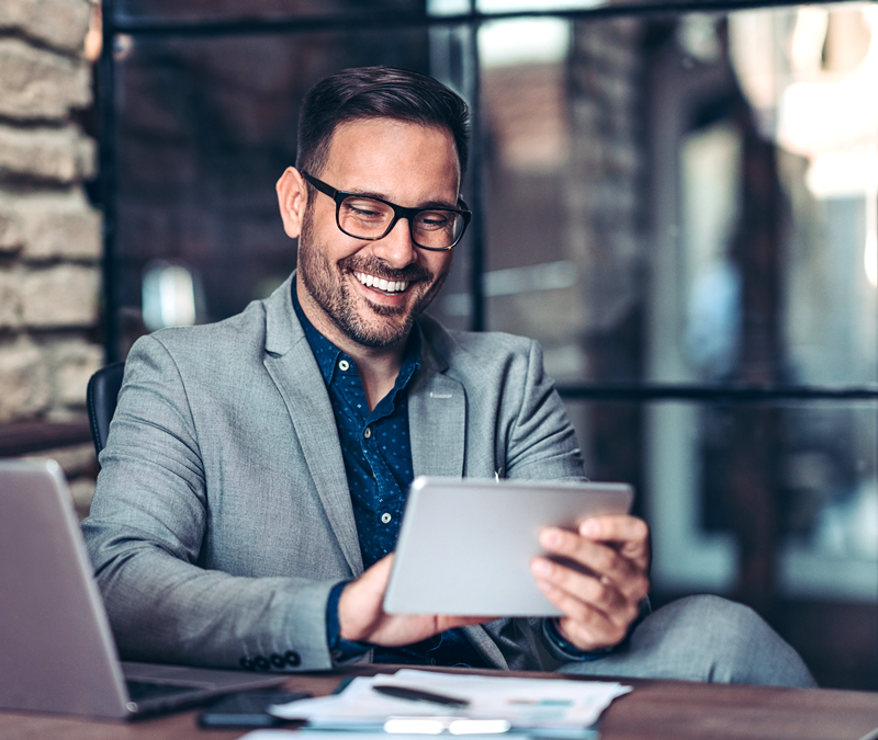 Man with tablet sitting at his desk